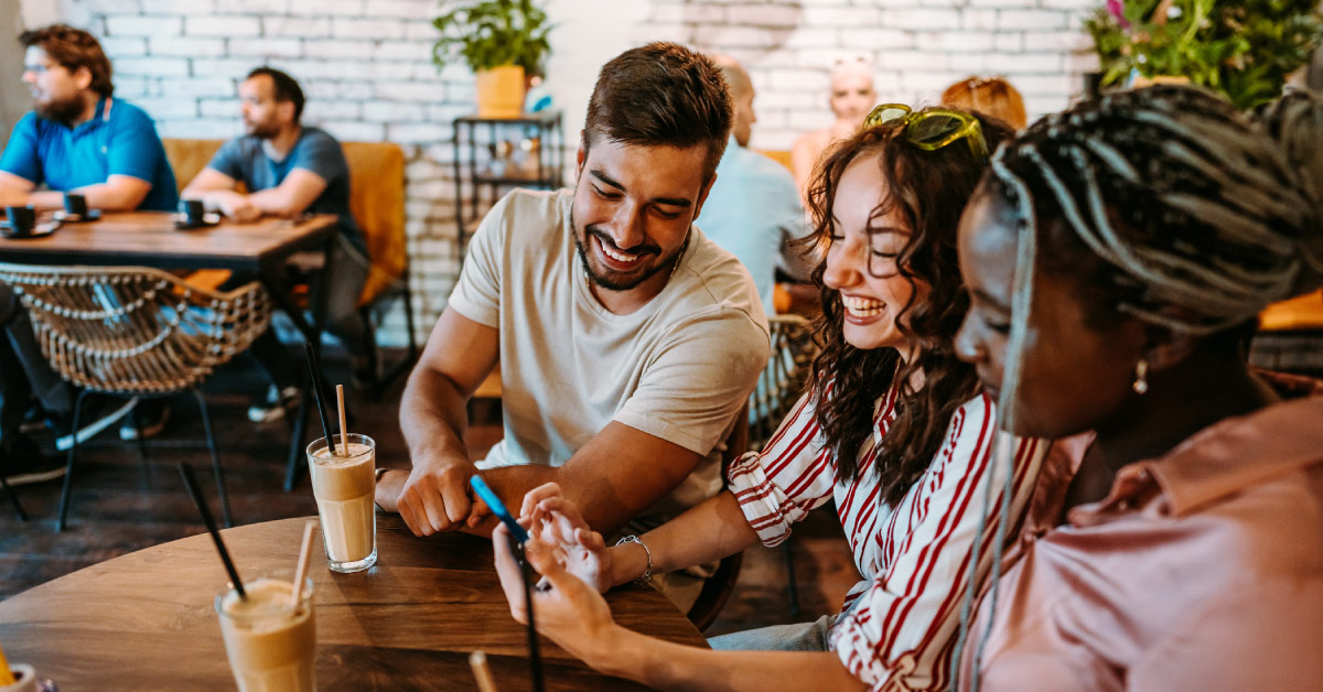 People in a coffee shop looking at a mobile website