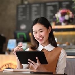 Woman integrating data on tablet 