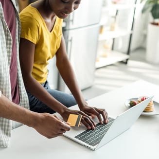 Couple purchasing product online on laptop