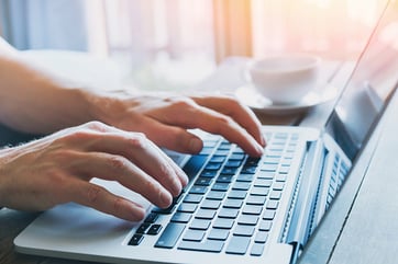 Person typing on a laptop