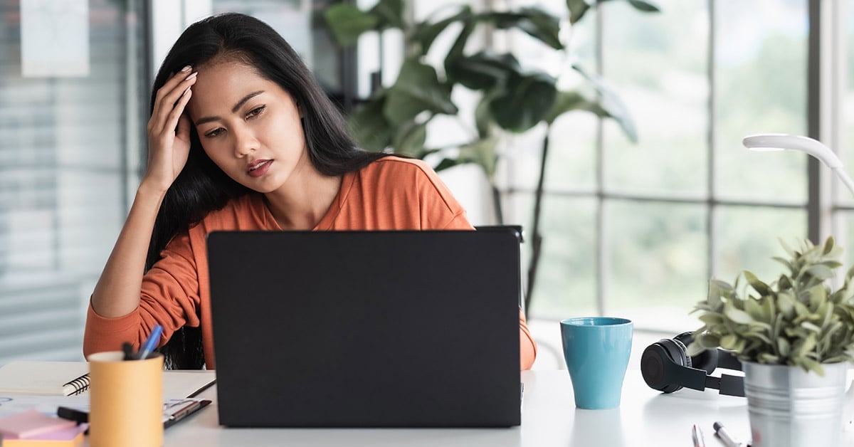 Employee at laptop, confused by HubSpot capabilities