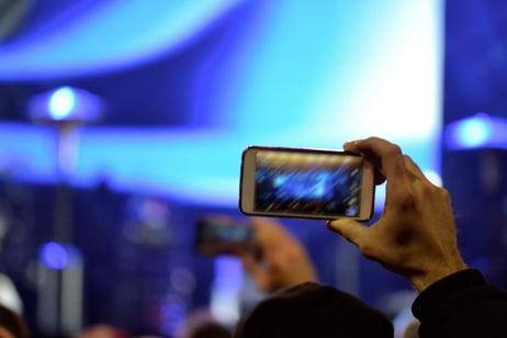 holding up phone at event