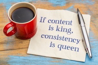 cup of coffee with napkin that has if content is king consistency is queen on it