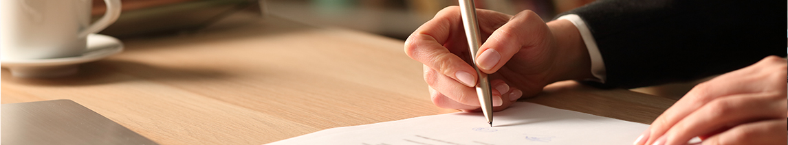person-writes-on-paper-with-pen