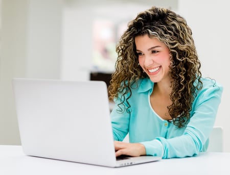 Business woman at the office working on a laptop.jpeg