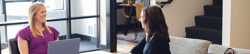 Two-women-have-conversation-in-office