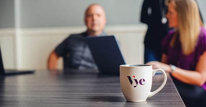 Vye marketing agency coffee cup on a table