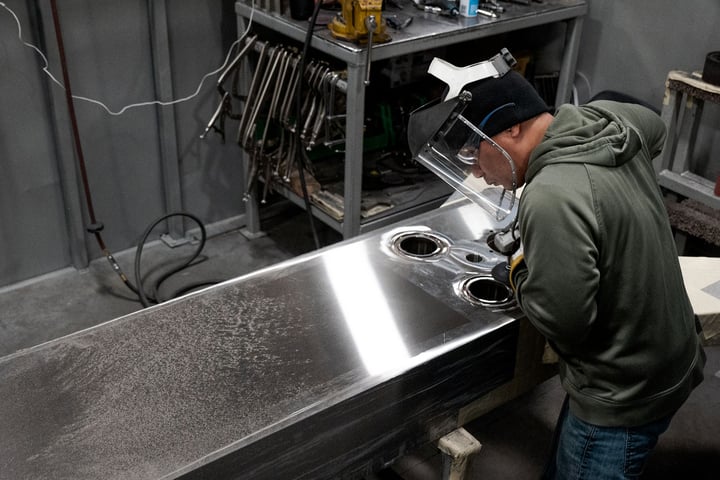 AGC worker work on plate heat exhanger plate.