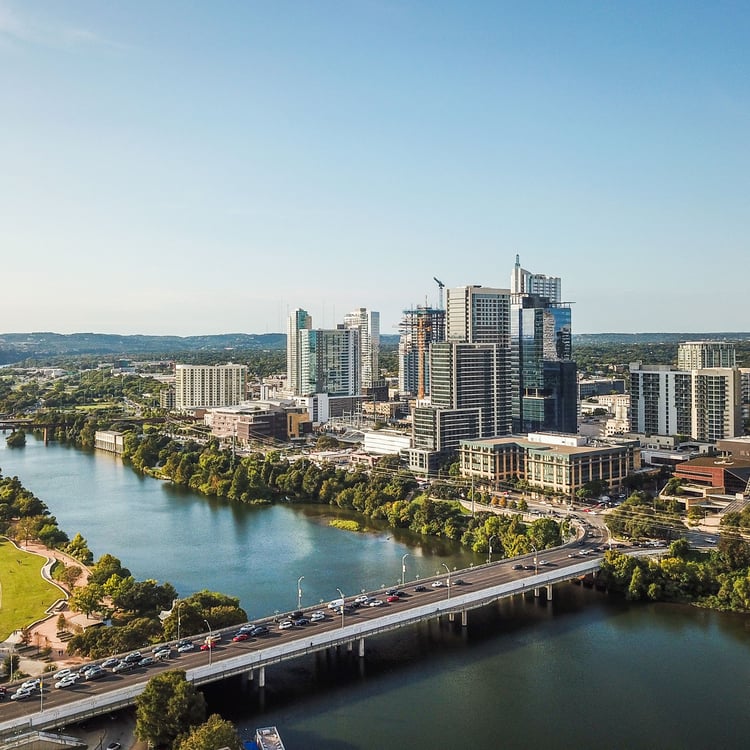 Skyline of large city near river.