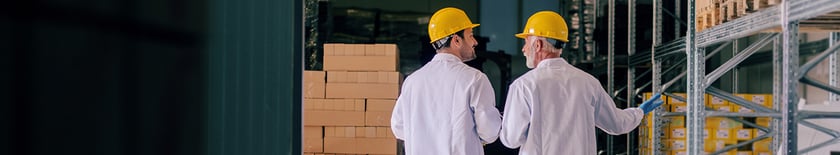 two-men-walk-through-warehouse